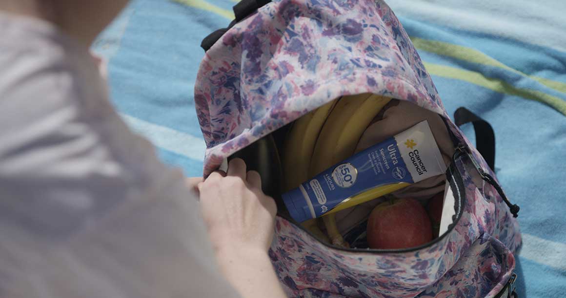Backpack with sunscreen and fruit