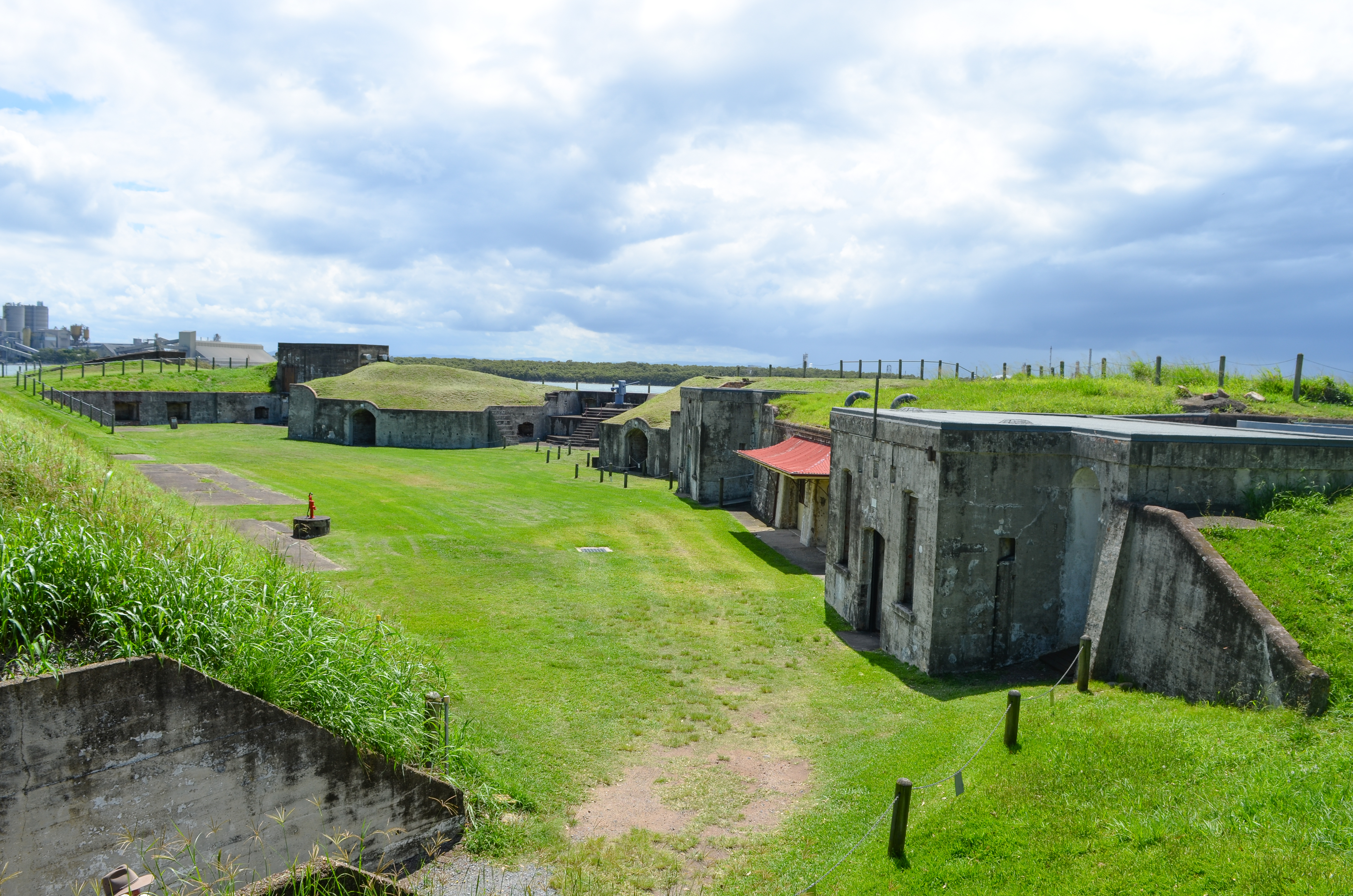 Ruins of buildings sit in green grassy surrounds.